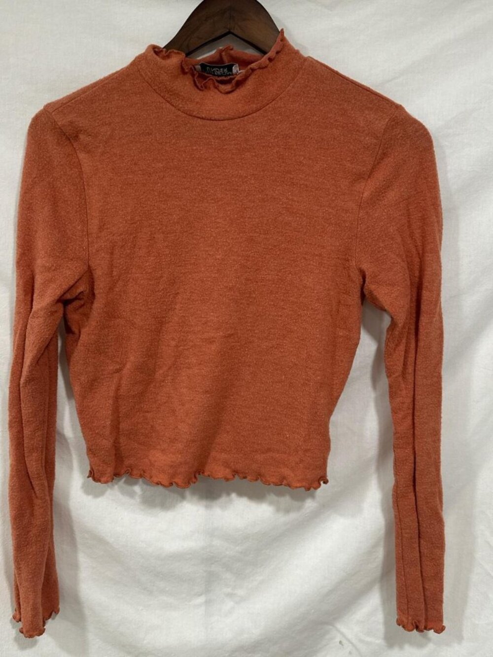 Orange cropped mock neck long sleeve top with ruffle